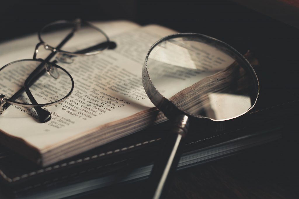 Glasses and magnifying glass on a book
